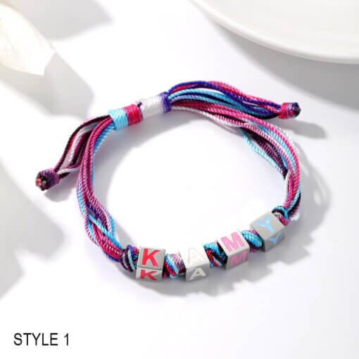 Girls’ bracelet with enamel letter charms in pink, blue, and purple